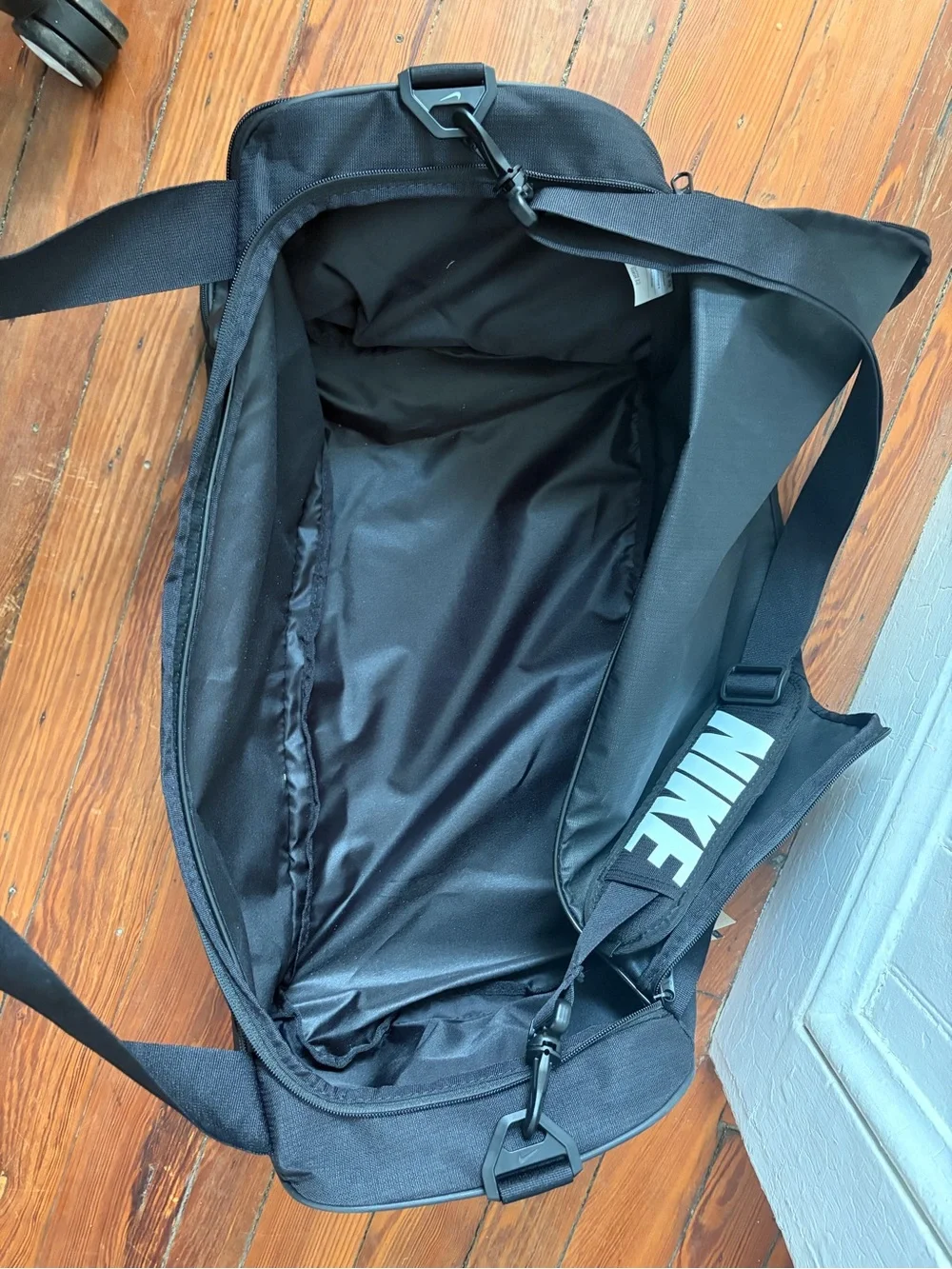 Nike Black Duffel Bag with White Swoosh and Strap Logo
